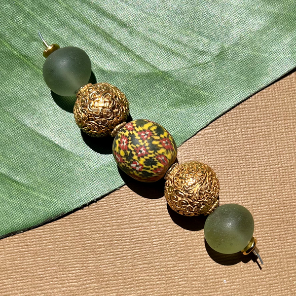 Gold metal beads and green Afghan glass, and viking bead strand