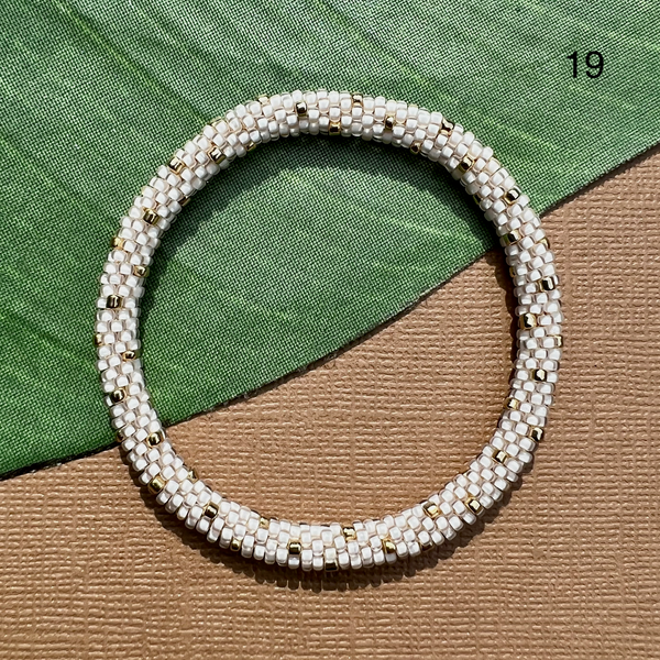 White size 11 inside color seed beads with gold polka dots. Beaded bangle bracelet that can be rolled on.