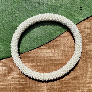 Creamy white beaded bangle.