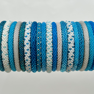 Light Blue and blue glass seed bead bangle bracelets.  Beaded bangles are crocheted and do have give to them.  One size fits most.