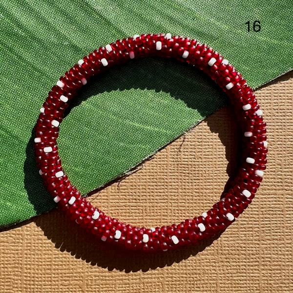 Translucent red glass seed bead bracelet with white polka dots. Beaded bangles can be rolled on - fit most. 