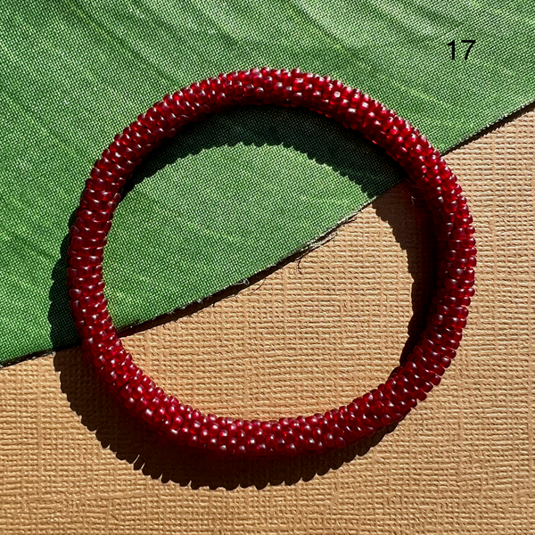 Solid red translucent glass seed beads crocheted into a beaded bangle. Beaded bangles can be rolled on - fit most.