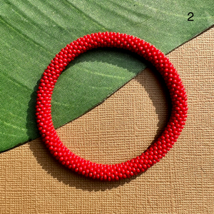Red glass seed bead bangle. Beaded bangle bracelets can be rolled on.