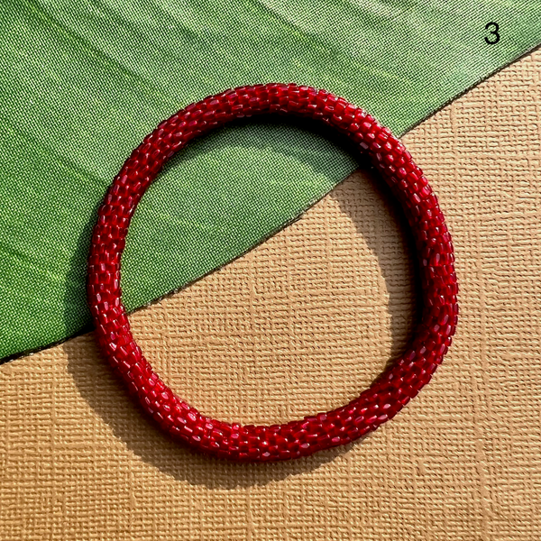 Dark red glass seed bead bracelet. Beaded bangle bracelets can be rolled on.