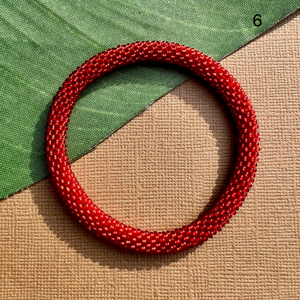 Red glass seed bead bracelet. Beaded bangle bracelets can be rolled on.