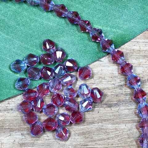 Vintage crystals from our estate collection. A 7mm pink and puple bicone. 